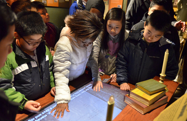 Students interact with exhibition touch-screens at the Ford’s Theatre Museum. Photo by Gary Erskine.