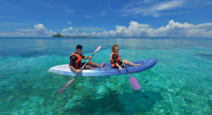 Travelers enjoy the crystal, clear waters off Malaysia's coast, courtesy Tourism Malaysia