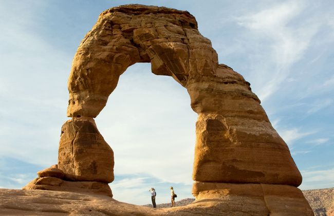 Travelers at the Delicate Arch in Arches National Park, courtesy NPS