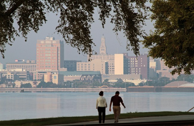 A couple walks by the Mississippi River, courtesy Quad Cities CVB