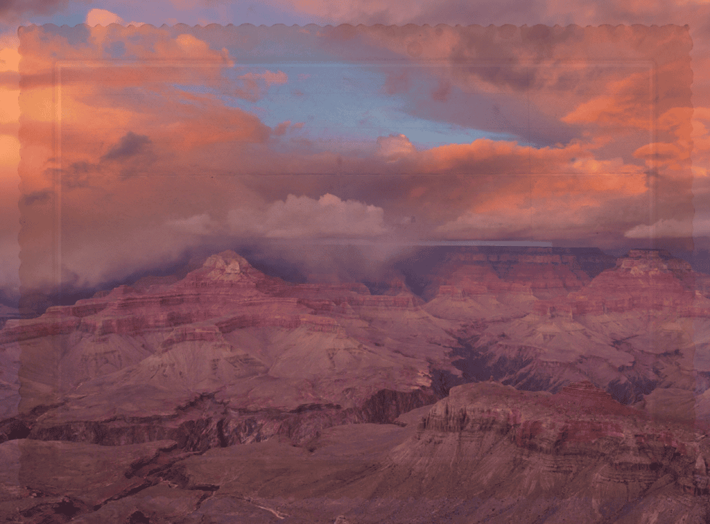 Panoramic Grand Canyon at sunset with orange and pink clouds above layered rock formations, in warm hues.
